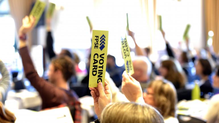 FPSE members holding up voting cards at 2017 AGM